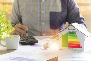 person-calculating-how-much-money-they-save-by-making-their-home-more-efficient