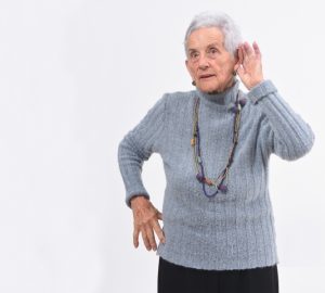 woman-with-hand-to-ear-listening-to-a-concerning-sound